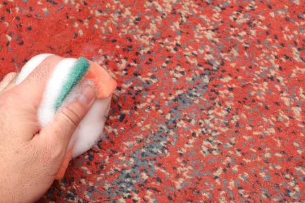 Scrubbing The Mat To Remove Stubborn Stains